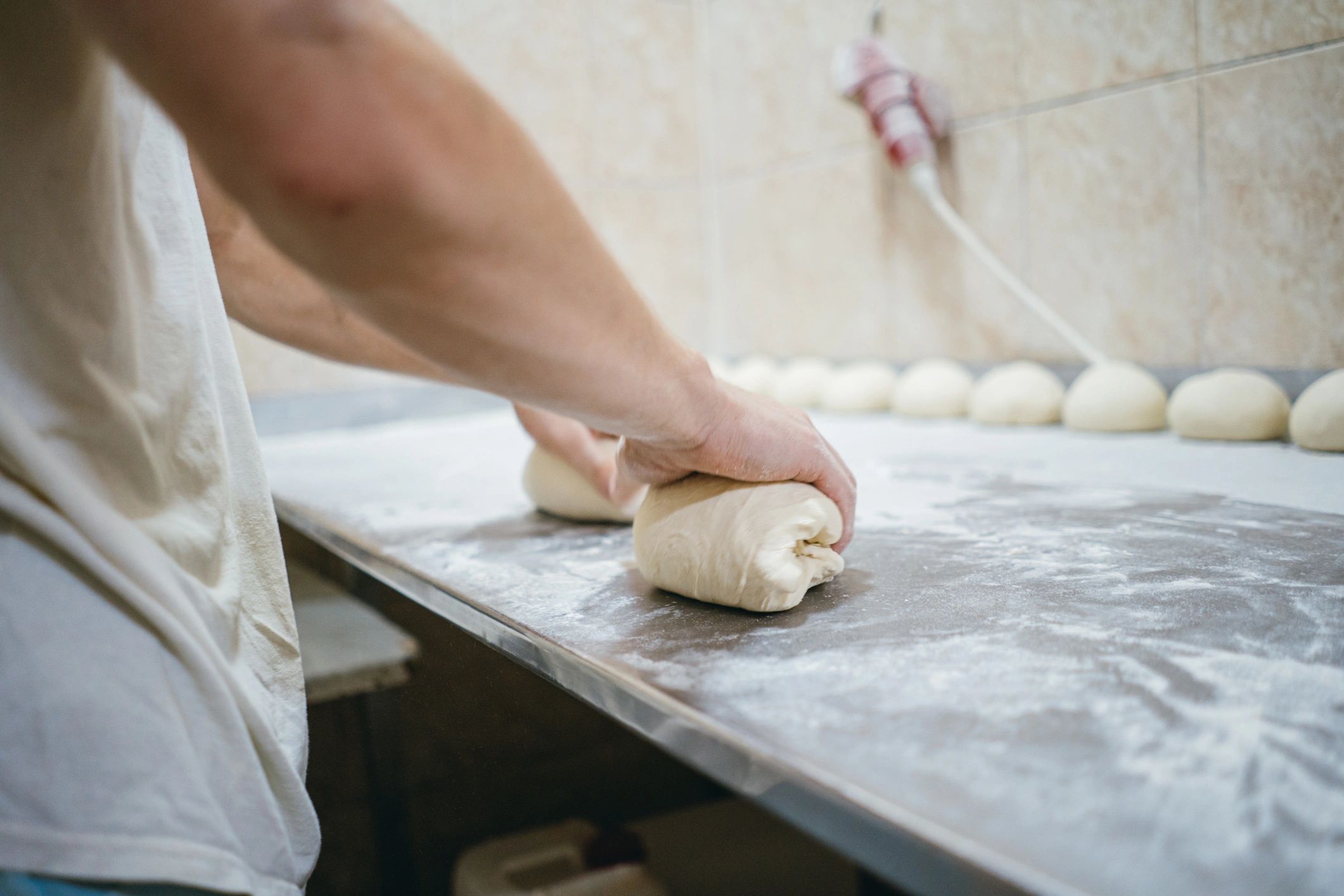 Baker preparing bread for the oven