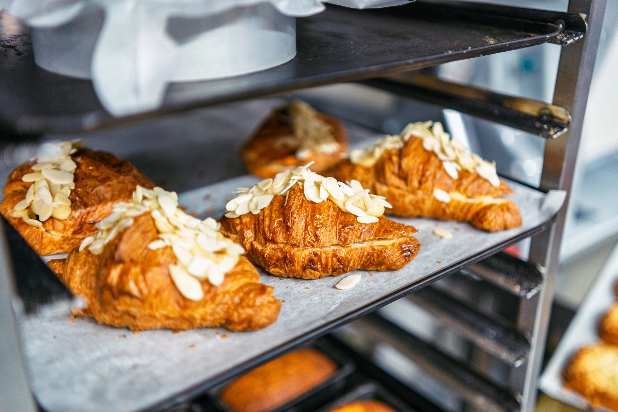 Fresh pastries cooling on a rack in a bakery