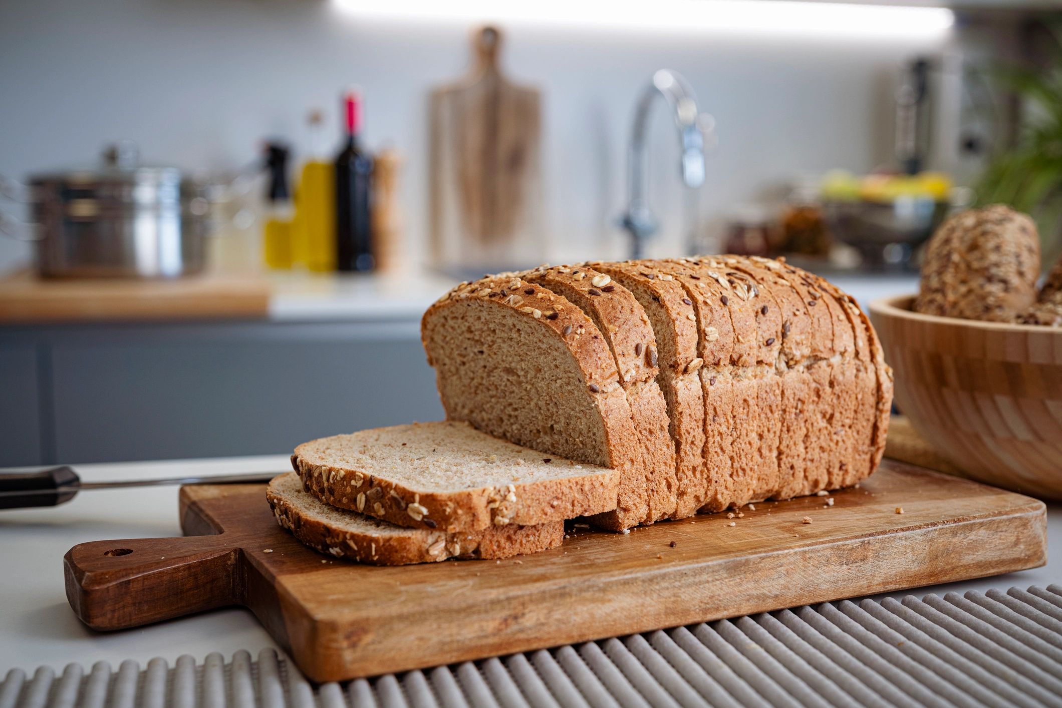 Sliced seeded bread on a kitchen counter